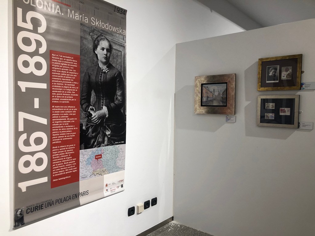 Exhibition panel about Maria Sklodowska-Curie, showing her biography and scientific achievements, accompanied by photographs and objects from the exhibit.