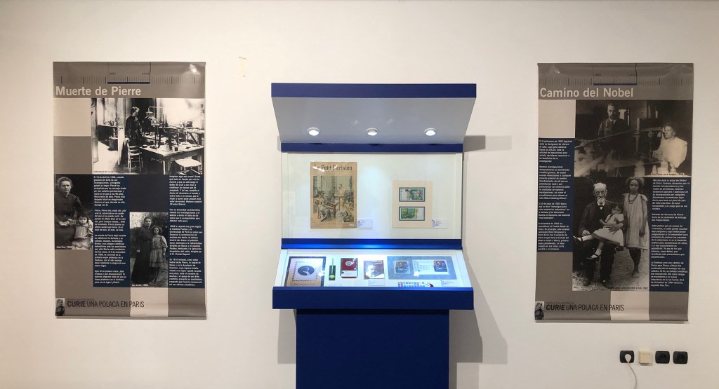 Display about the life and work of Maria Sklodowska-Curie with informational posters and display cases at the Casa de las Ciencias in Logrono.