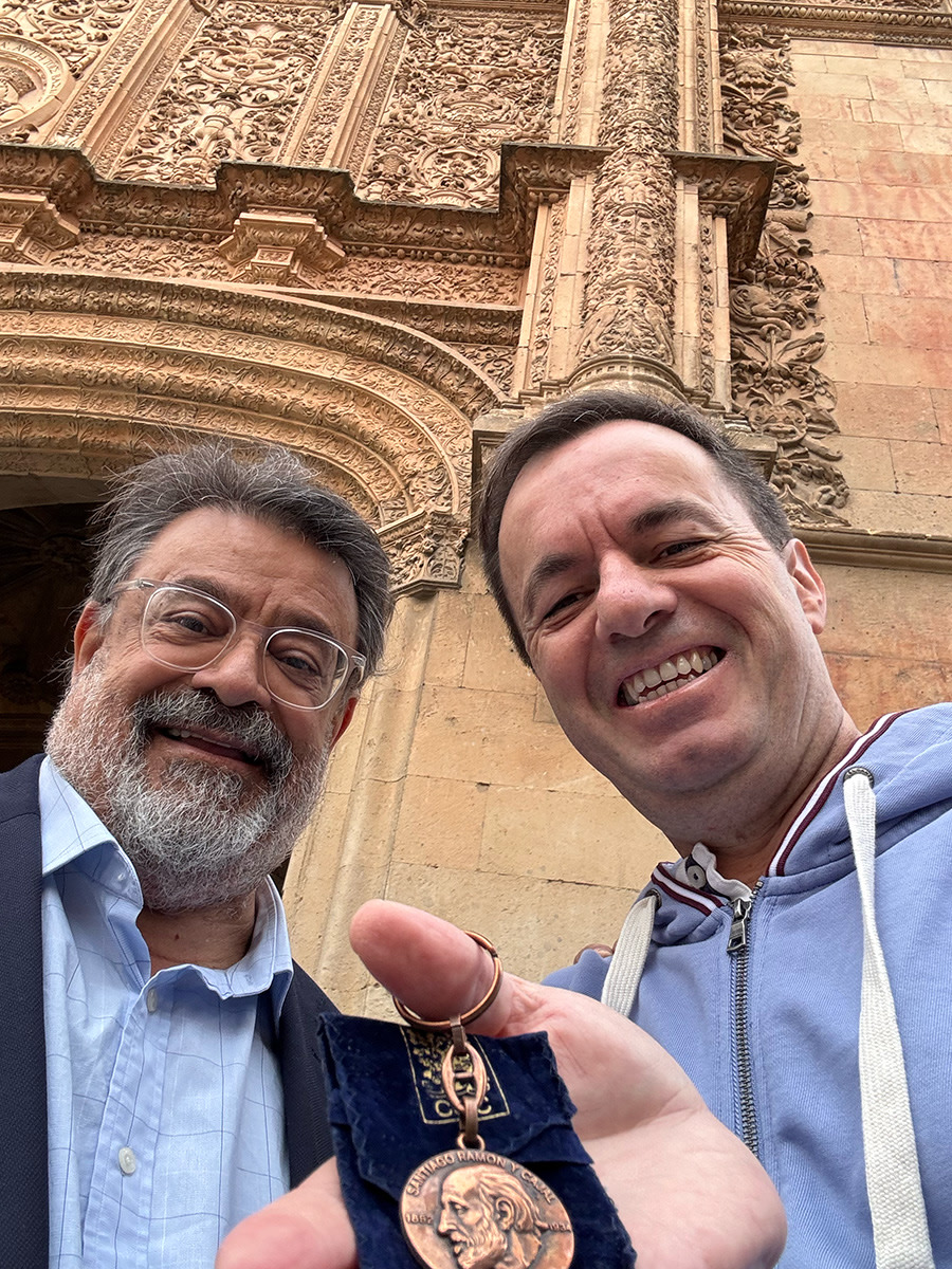 Two men posing with Cajal portrait keyring