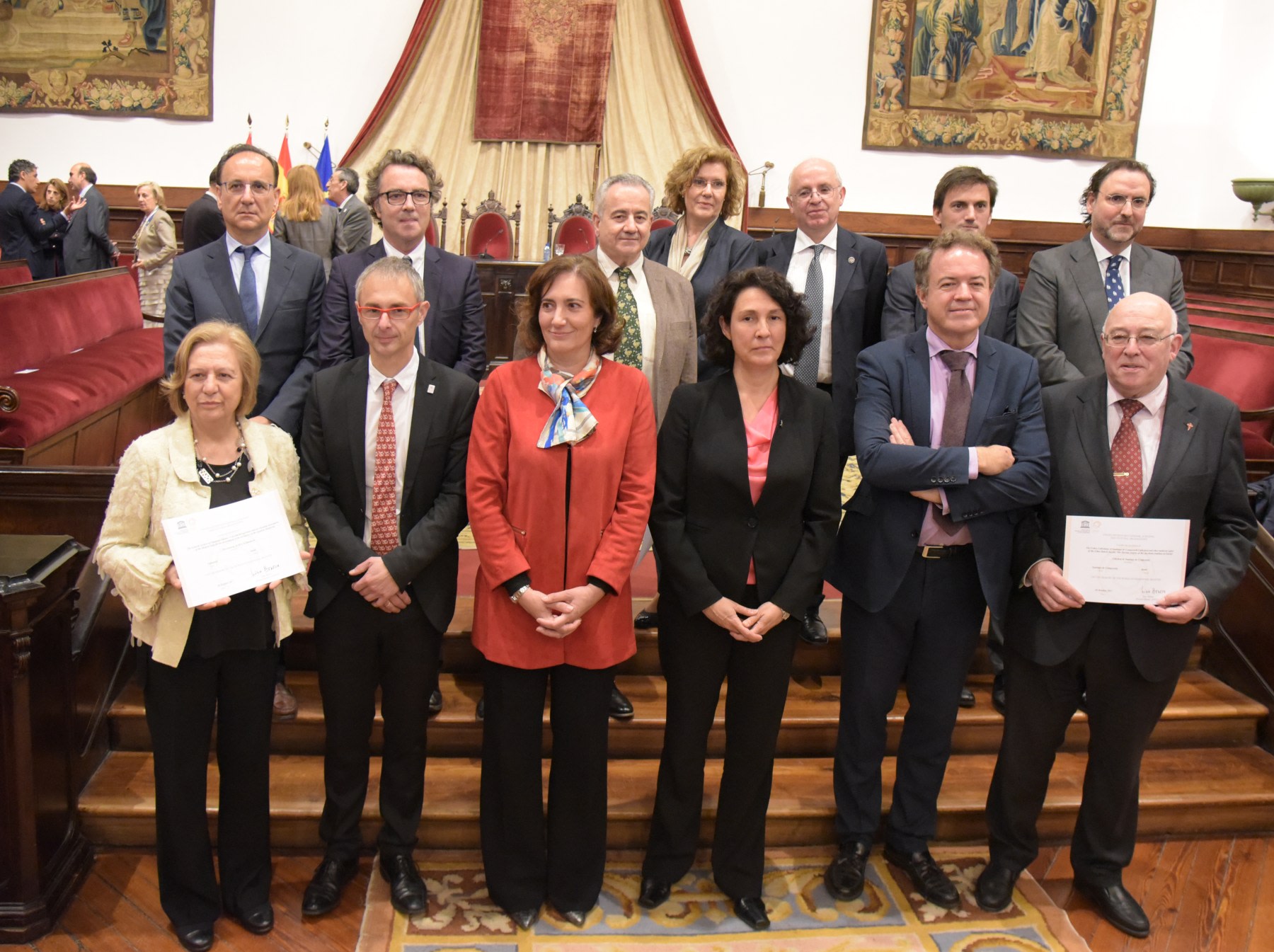 A group of people posing on stage, several holding certificates, at a formal event related to Santiago Ramon y Cajal and the Spanish School of Neurohistology.